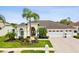 Charming single-story home featuring a well-manicured lawn and a spacious three-car garage at 8137 Morning View Dr, Hudson, FL 34667