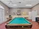 Game room featuring a pool table, checkered wallpaper, and two white ceiling fans at 8137 Morning View Dr, Hudson, FL 34667