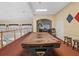 Upstairs game room with a brown covered pool table, stools, and chairs in the background at 8137 Morning View Dr, Hudson, FL 34667