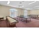 Game room with ping pong tables, a shuffleboard table and a large mirror on the back wall at 8137 Morning View Dr, Hudson, FL 34667