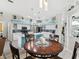 Open kitchen and dining area featuring a large island, white cabinets, and stylish pendant lighting at 8137 Morning View Dr, Hudson, FL 34667