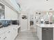 Bright kitchen boasts white cabinetry, modern appliances, mosaic tile backsplash, and sleek countertops at 8137 Morning View Dr, Hudson, FL 34667