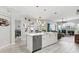 Kitchen with white cabinets, stainless steel appliances, and an open design to living spaces at 8137 Morning View Dr, Hudson, FL 34667