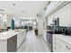 Kitchen with white cabinets, modern appliances, and an open view to the living room at 8137 Morning View Dr, Hudson, FL 34667