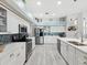 Bright kitchen featuring white cabinets, stainless steel appliances, and a stylish blue backsplash at 8137 Morning View Dr, Hudson, FL 34667