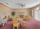 Cozy living room with vintage furniture, warm lighting, and a window with natural light at 8137 Morning View Dr, Hudson, FL 34667