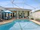 Inviting screened-in pool area offers sunny lounge areas, patio furniture, and water feature at 8137 Morning View Dr, Hudson, FL 34667