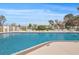 Community outdoor pool surrounded by lounge chairs for residents of the complex to relax at 8137 Morning View Dr, Hudson, FL 34667