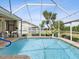 Inviting screened-in pool area offers sunny lounge areas, shade, and backyard views at 8137 Morning View Dr, Hudson, FL 34667