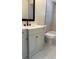 Bathroom showcasing a vanity with white countertop, black faucet, and white tiled walls and flooring at 8413 Monarch Dr, Port Richey, FL 34668