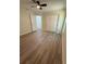 Bedroom showcasing wood-look floors and a ceiling fan, adjacent to the hallway and closet at 8413 Monarch Dr, Port Richey, FL 34668