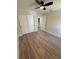 Bedroom with luxury vinyl flooring, ceiling fan and walk-in closet at 8413 Monarch Dr, Port Richey, FL 34668