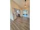 Dining area with modern lighting, wood floors, and access to the updated kitchen and screened porch at 8413 Monarch Dr, Port Richey, FL 34668