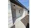 Welcoming front entrance featuring a stylish gray door, modern lighting, and manicured landscaping at 8413 Monarch Dr, Port Richey, FL 34668
