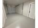 Spacious garage with white painted floor and walls at 8413 Monarch Dr, Port Richey, FL 34668