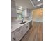 Clean bright kitchen featuring white cabinets, quartz countertops, undermount sink and stainless steel appliances at 8413 Monarch Dr, Port Richey, FL 34668