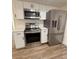 Recently updated kitchen features white cabinetry, stainless steel appliances and quartz countertops at 8413 Monarch Dr, Port Richey, FL 34668