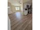 Open living space showing luxury vinyl plank flooring, a fan, and the flow into the kitchen at 8413 Monarch Dr, Port Richey, FL 34668