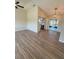 Open-concept living room leading to a bright kitchen and backyard access through sliding glass doors at 8413 Monarch Dr, Port Richey, FL 34668