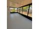 Enclosed screened porch with aluminum frame and concrete flooring at 8413 Monarch Dr, Port Richey, FL 34668