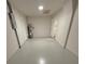 Storage room with painted floors, water heater, and electrical panel at 8413 Monarch Dr, Port Richey, FL 34668