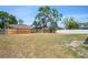 Large backyard features a wood fence and some grass at 8461 Apple Orchard Rd, Spring Hill, FL 34608