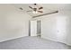 Spacious bedroom with carpet flooring, a ceiling fan, a walk-in closet, and access to a private bathroom at 8461 Apple Orchard Rd, Spring Hill, FL 34608