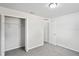 Carpeted bedroom with a closet and an open door at 8461 Apple Orchard Rd, Spring Hill, FL 34608