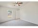 Bright bedroom features vaulted ceiling, ceiling fan, window with backyard view, and neutral carpet at 8461 Apple Orchard Rd, Spring Hill, FL 34608