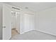 Carpeted bedroom with double closets and easy access to the hallway at 8461 Apple Orchard Rd, Spring Hill, FL 34608