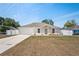Charming single-story home with a two-car garage, concrete driveway, and manicured lawn at 8461 Apple Orchard Rd, Spring Hill, FL 34608