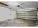 Spacious garage interior with overhead door, opener, and access door at 8461 Apple Orchard Rd, Spring Hill, FL 34608