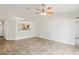 Bright living room featuring tile flooring and a view of the kitchen through an open partition at 8461 Apple Orchard Rd, Spring Hill, FL 34608