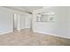 Bright living room featuring tile flooring, a kitchen view, and doorways to other rooms at 8461 Apple Orchard Rd, Spring Hill, FL 34608