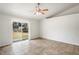 Bright living room featuring tile flooring, sliding glass doors, and backyard views at 8461 Apple Orchard Rd, Spring Hill, FL 34608