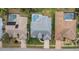Aerial view showcases neighboring backyard pools; this property has a screened in lanai and updated roof at 8514 Ashbury Dr, Hudson, FL 34667