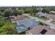 Aerial view of property highlighting a screened-in pool, and views of the surrounding greenery at 8514 Ashbury Dr, Hudson, FL 34667