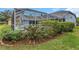 Backyard shows green lush grass and landscaping surrounding the screened in pool at 8514 Ashbury Dr, Hudson, FL 34667
