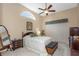 Traditional primary bedroom with a ceiling fan, and floral comforter. Natural light from the arched window at 8514 Ashbury Dr, Hudson, FL 34667