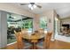 Casual dining area with views of the pool and outdoor space, featuring a rustic table at 8514 Ashbury Dr, Hudson, FL 34667