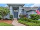 Elegant double front doors with a transom window and lush landscaping create a grand entrance at 8514 Ashbury Dr, Hudson, FL 34667