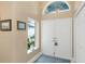 Welcoming front entrance with double doors, natural light, and tiled floor at 8514 Ashbury Dr, Hudson, FL 34667