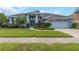 Charming home boasts lush landscaping, an American flag, and a welcoming entrance at 8514 Ashbury Dr, Hudson, FL 34667
