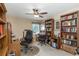 Well-organized home office with multiple desks, bookshelves, and a ceiling fan at 8514 Ashbury Dr, Hudson, FL 34667