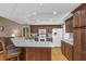 Modern kitchen with wood cabinets, stone countertops, stainless appliances, and open layout at 8514 Ashbury Dr, Hudson, FL 34667