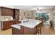 Open kitchen design with stone countertops, wood cabinets, and peninsula seating at 8514 Ashbury Dr, Hudson, FL 34667