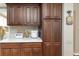 A kitchen with wood cabinets, white countertop, and various kitchen appliances at 8514 Ashbury Dr, Hudson, FL 34667