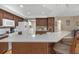Spacious kitchen with stone countertops, wood cabinets, and seating at the peninsula at 8514 Ashbury Dr, Hudson, FL 34667
