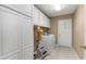 Functional laundry room with ample storage cabinets and modern washer and dryer at 8514 Ashbury Dr, Hudson, FL 34667