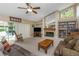 Comfortable living room with a fireplace, sliding doors to the pool, and neutral decor at 8514 Ashbury Dr, Hudson, FL 34667